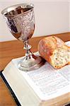 Bible, bread, and wine cup. Symbol of the Lord's Supper.