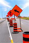 Road construction signs and cones on a city street