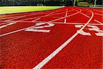 Curving lanes of a red race track and green football field