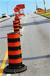 Road construction signs and cones on city street