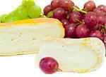 Cheeses with green and red grapes on a white background