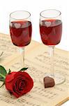 Preparing to celebrate - with all the classic elements - rose, red wine, music and chocolate (isolated, clipping path)