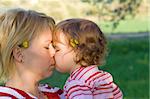 Baby girl kissing her mother
