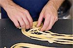 A detail of homemade fettuccine being rolled into a nest