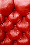 Background image of plush red leather from an antique seat.