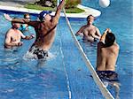 Men playing water polo in a swimming pool