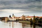 The old town bridge and tower in the background behind some buildings in old town Prague