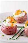 Roasted red potato topped with cream, salmon roe and fresh chives