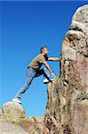 Man climbing to the top of the mountain