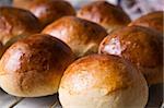Close up detail of freshly baked hot cross buns in romantic renaissance lighting and a shallow depth of field.