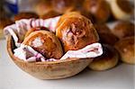 Close up detail of freshly baked hot cross buns in romantic renaissance lighting and a shallow depth of field.