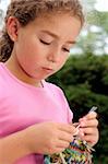 Cute girl knitting. Motion blur on hand.