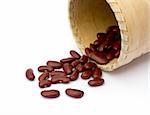 Kidney beans spilling out over a white background