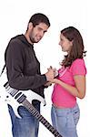 Young electric guitar player giving an autograph to a beautiful young girl