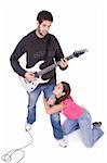 Young electric guitar player with beautiful young girl grabbing his leg