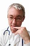 concentrated doctor in glasses with stethoscope looking to the camera