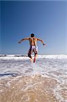 a men jumping in a para dise beach (moving blur)