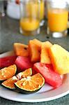 Platter of cut tropical fruits watermelon orange