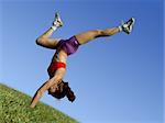 Girl exercising outdoors on the grass