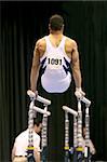 Gymnast doing handstand on parallel bars