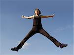 Young woman jumping high in the sky