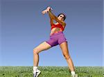 Girl exercising outdoors on the grass