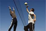 2 men playing volleyball