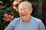 Old man laughing in his garden