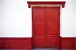 Red door, White Wall on a colonial style building in Puno, Peru