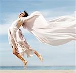 Woman jumping on the beach