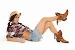 Very sexy Caucasian woman dresses as a cowgirl laying on white background