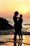 Couple kissing on the beach at sunset