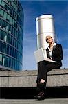 A beautiful young female executive using her laptop in a hi-tech business environment