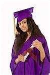 Young female in graduation gown holding her diploma