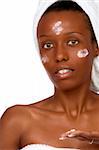 African-American girl applying facial skincare product (isolated)
