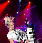 Beautiful punk rocker playing key-tar during concert