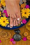 Spa treatment with aromatic gerbera daisies, healing stones, olive oil soaps and mineral water