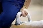 Closeup of a man competing on pommel