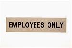 Employees only sign against white background.