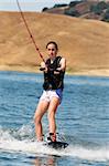 Girl wakeboarding on the lake