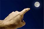 Man's Hand pointing the moon