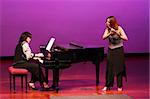 Flutist and pianist girls on stage