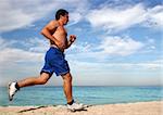 Young man running alone on the beach