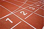 numbers of a racetrack, on red tarmac, for runners