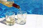 serving 2 glasses of white wine at the swimming-pool