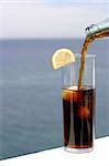 a cold refreshment at the sea, glass of cola