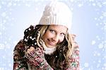 winter portrait of a beautiful woman is freezing with a cap and a scarf and snowflakes