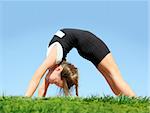 Cute girl doing bridge in the park