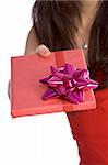 Close up of woman handing wrapped gift