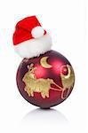 One red and gold Christmas ball with hat, reflected on a white background